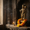 Handcrafted Hanuman murti with gada in a mandir niche with a diya and marigold garland