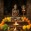 Handcrafted Shiva murti with trishul, diya, and marigold garland