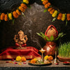 Navratri home mandir with Ganesha murti, kalash, marigolds and diyas