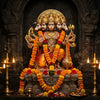 Handcrafted Panchamukhi Hanuman murti with gada in a mandir niche with diyas and marigolds
