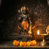 Handcrafted Hanuman murti with gada in a mandir niche beside a lit diya