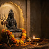 Handcrafted Shiva murti with trishul and crescent moon beside a diya and marigold garland