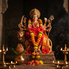 Handcrafted Goddess Durga murti on a lion surrounded by diyas and marigold garlands