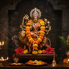 Handcrafted Durga murti on a lion in a home mandir with marigold garlands and diyas